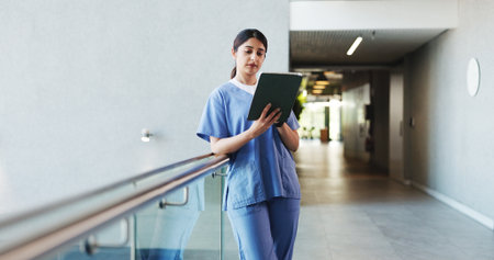 Hospital, woman and nurse on tablet in lobby for patient results, medical report and research. Healthcare, doctor and person on digital tech for consulting, surgery schedule and planning in clinicの写真素材
