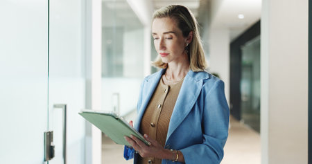 Employee, reading and woman with tablet, office and browsing for brand awareness on social media app. Business, digital marketing and schedule post with tech, scroll or person with ad campaign on webの写真素材