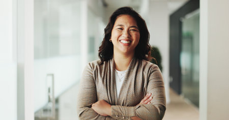 Happy woman, portrait and business with confidence for corporate startup or development in office. Female person, employee or smile with arms crossed for career pride or job opportunity in workplaceの写真素材