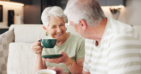 Coffee, laughing and retirement with old couple on sofa in living room of home together for break....