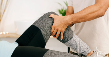 Physiotherapy, knee pain and physical therapist with woman in clinic for muscle recovery support....