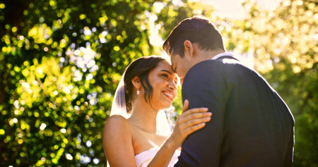 Wedding, couple and smile in park with nature, support and celebration for bridal union or marriage. Happy bride, groom and people in garden low angle for life partner, commitment or together outdoorの写真素材