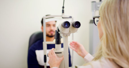 Man, eye test and lamp machine with optometrist inspection, laser correction and cornea procedure. People, equipment and assistance for ophthalmology assessment, retinal evaluation and testing visionの写真素材