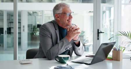 Happy, business man and laptop with thinking in office for financial solution, planning and ideas. Accountant, mature person and insight at firm for finance decision, investment opportunity or visionの写真素材