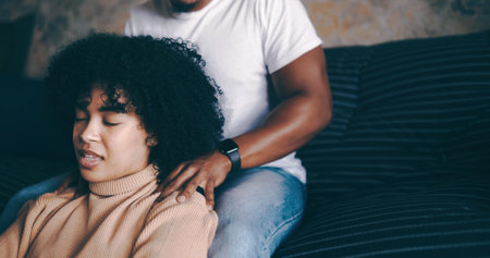 Woman, relax and shoulder with massage in home for bonding, pamper or valentines day on sofa. Female person, man or couple with treatment on couch for anniversary gift, date or stress relief in houseの写真素材