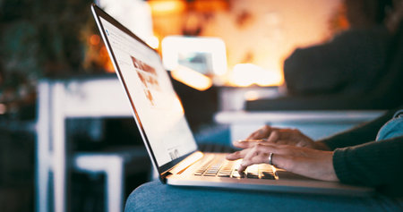 Night, woman and hands in home with laptop for marketing campaign planning, remote work or report. Evening, person and typing email in apartment with computer, freelance advertising research or idea.の写真素材