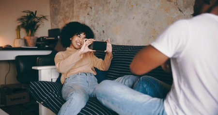 Relax, woman and photography of partner on sofa for relationship memory, support and weekend break. Love, couple or happy with picture in home for status update, social media post or bonding togetherの写真素材