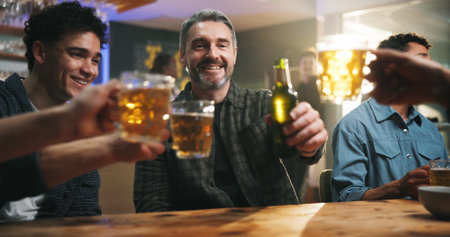 Smile, people and cheers with alcohol at bar for sports match, football competition and reunion. Friends, toast and beer for social gathering, world cup tournament and happy hour for bonding togetherの写真素材