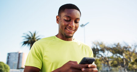 Fitness, phone and black man outdoor with smile, message update or exercise post on social media....