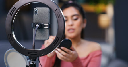Ring light, phone and recording with influencer in home for makeup tutorial, video or advice on web...