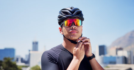 Sports, helmet and man with sunglasses outdoor ready for exercise, training and active hobby in city. Fitness, athlete and person with safety gear, polarized lens and protection for cycling workoutの写真素材