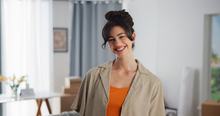 Property, portrait and woman in house with confidence, fresh start and investment in dream home. Success, real estate and girl in living room with pride, relocation and achievement for new homeownerの写真素材