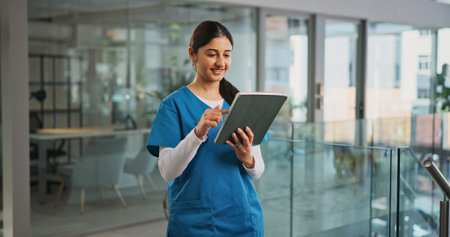 Healthcare, nurse and happy woman in hospital, tablet and internet with email notification. Person,...