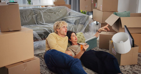 Couple, tablet and new house with boxes on floor, point and online shopping for interior design....