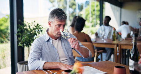 Restaurant, smell and man with glass for wine tasting, aged flavor and identify drink notes at...