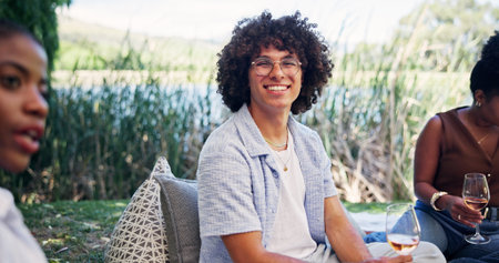 Portrait, wine tasting or man outdoor with friends, social gathering or bonding with flavor sampling. Happy, reunion or people in nature with alcohol drink, connection or summer event in sip activityの写真素材