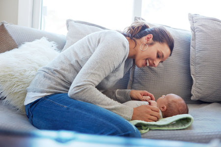 Happy mom, sofa and playing with baby in home with blanket for comfort, love or care. Mother, child...