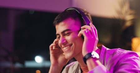 Smile, man and headphones in home at night for streaming podcast, listening to music and weekend....