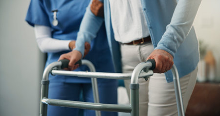 Balance, hands and walking frame of old person with nurse in home living room for rehabilitation....