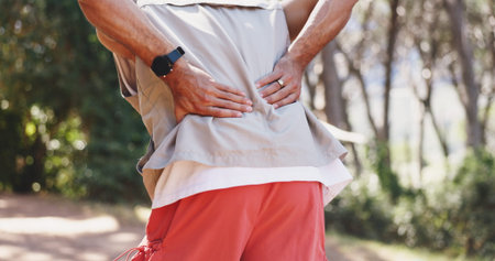 Man, hands and fitness in nature with back pain, muscle spasm and hiking injury. Male person,...