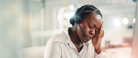 Tired, consultant and woman with headset, office and thinking of target increase, stress or burnout. Call center, agent and black person with headache for sales pressure, banner and telemarketingの写真素材