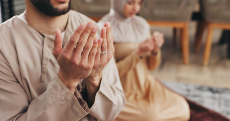 Muslim, couple and hands in prayer for faith with worship, salah or routine for Islam in home....