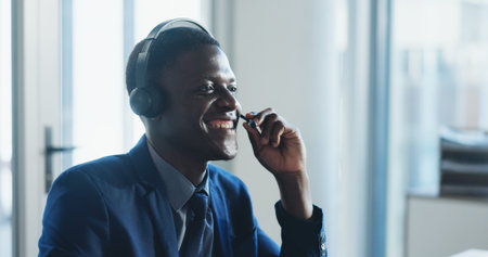 Call center, smile and black man in office with headset, contact us or advice in crm service....