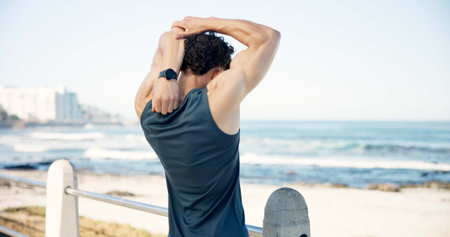 Stretching, runner and back of man by ocean to start workout, exercise and training outdoor....