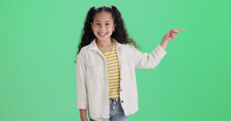 Green screen, pointing and girl with smile for portrait, promotion and opportunity for advertising....