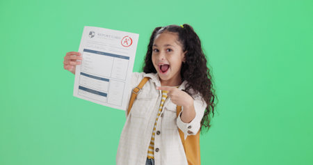 Happy student, green screen and girl with report card, pointing and excited on studio background....
