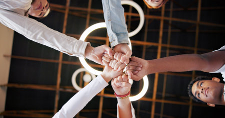 People, meeting and unity with fist bump below for collaboration, inclusion or mission together. Low...