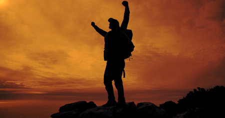 Person, silhouette and cheering for hiking on mountain for trekking, freedom and fitness success....