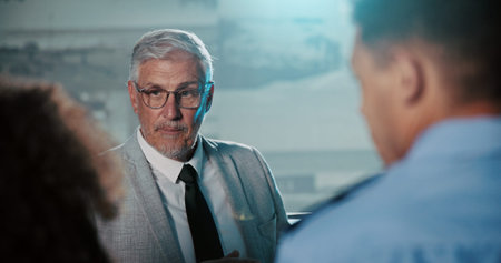 Government, presentation and team in control room with man for strategy, planning for satellite surveillance. Security, briefing and people in cctv command center at intelligence agency for meetingの写真素材