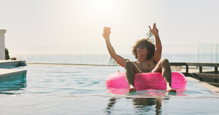 Swimming pool, party and man with vacation, sunshine and relax with weekend break. Water, floating...