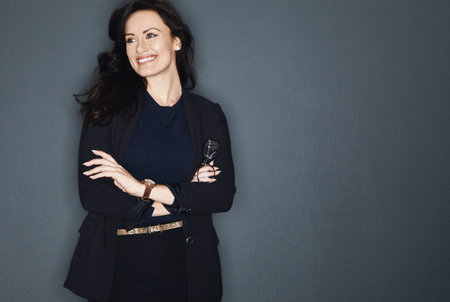 Businesswoman, smile and thinking in studio with arms crossed, vision and idea for marketing...