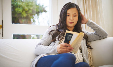 Pregnant woman, reading and sofa with book for literature, knowledge or story in home. Maternity,...