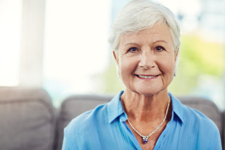 Portrait, senior woman and smile on couch to relax, morning peace and confidence for pension...