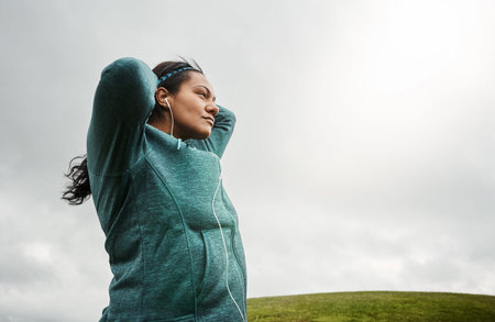 Fitness, woman and reflection outdoor with earphones, exercise break and music playlist for...