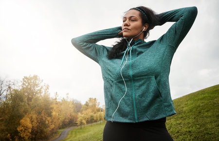 Earphones, woman and thinking on hill for fitness, outdoor training reflection and planning running...