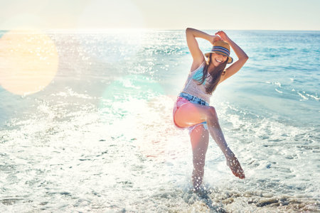 Splash ocean and travel with woman at beach for summer vacation, getaway trip and adventure. Seaside...