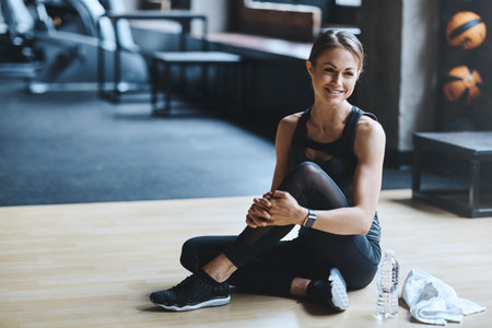 Break, thinking or happy woman in gym for fitness, training reflection or introspection for body...
