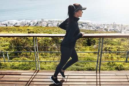Exercise, woman and running outdoor on bridge for cardio wellness, body health and endurance....