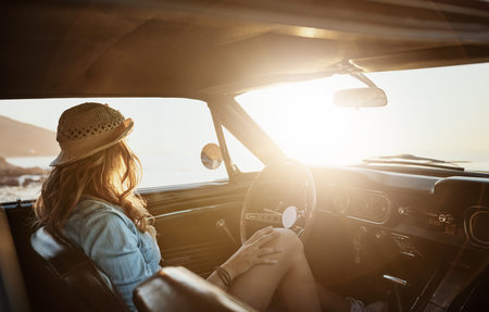 Ocean, relax and woman in car for adventure, lens flare and commute for summer holiday. Vehicle,...