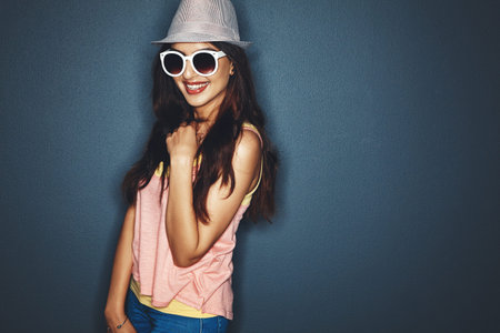 Smile, woman and fashion with hat in studio background, chic style and casual clothes. Mockup space,...
