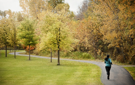 Back, woman and running in park with fitness, endurance training and exercise for wellness benefits....