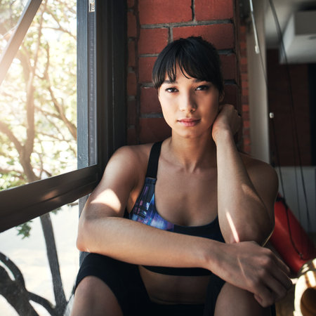 Fitness, portrait and window with woman in gym for training or workout break and recovery. Exercise,...