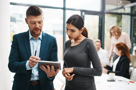 Businessman, woman and tablet at office meeting with feedback, insight or advice at insurance...