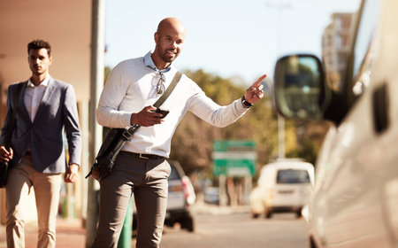 Gesture, business and man in city to travel, taxi for journey and smartphone for request. Happy, professional and person in street, cellphone and hailing service for ride, transportation and signの写真素材