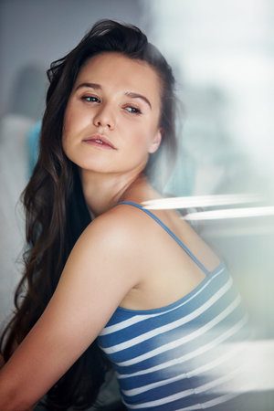 House, thinking and woman on sofa to relax, contemplation and reflection for memory. Apartment, daydreaming and person in lounge for break, decision and thoughtful with wonder, window and rememberの写真素材