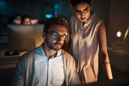 Night, manager or employee with reading in office, project feedback or collaboration for...